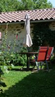 Table zellige extérieure avec fauteuil et parasol © I. Chapuis